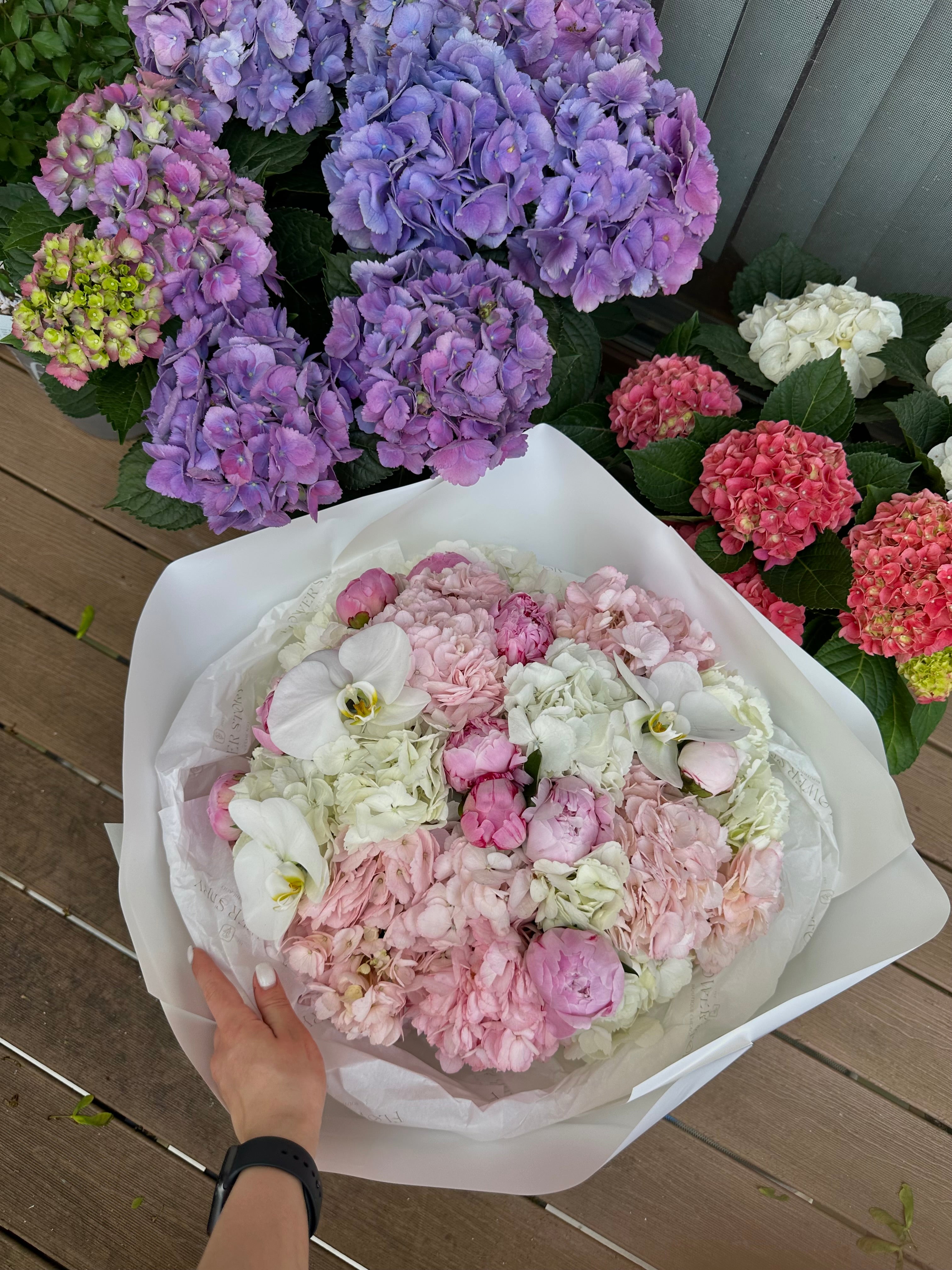 Bouquet with peonies, orchids, and hydrangea.