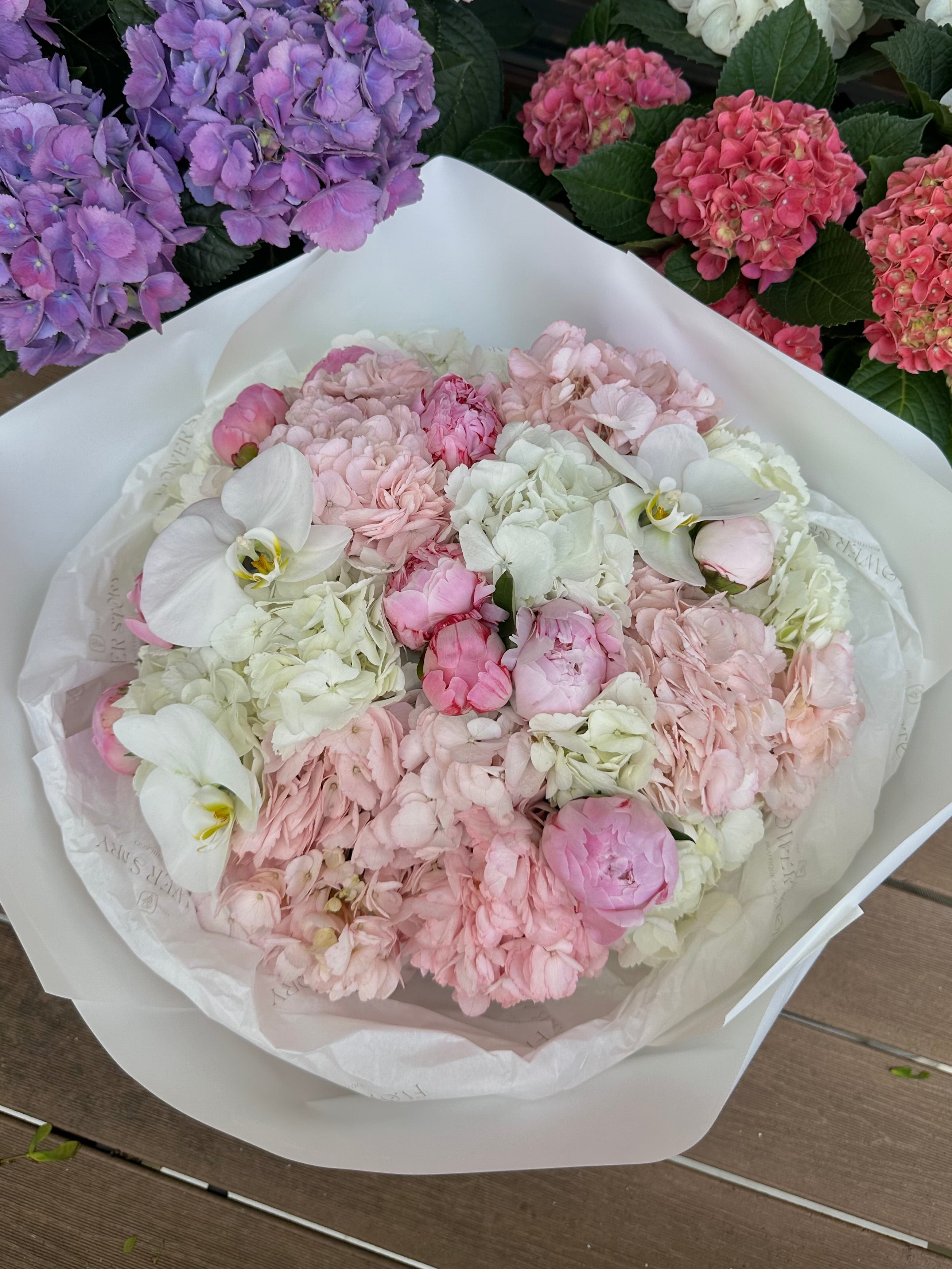 Bouquet with peonies, orchids, and hydrangea.