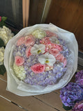 Bouquet of purple and pink hydrangeas, orchids & roses