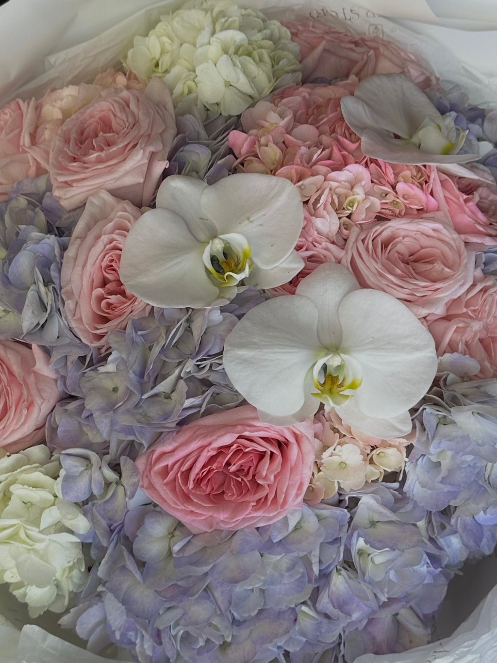 Bouquet of purple and pink hydrangeas, orchids & roses