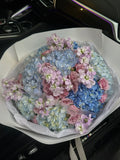 Mix bouquet of blue hydrangeas, purple spray roses & stock