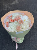 Mix bouquet of hydrangeas, carnations, orchids, and spray roses